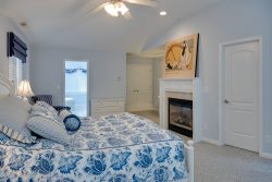 blue master bedroom with fireplace