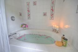 bed and breakfast bath with candles and rose petals
