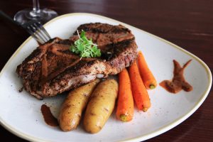 beef steak potatoes carrots plated