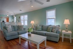 nautical themed living room with seafoam blue walls and sofas
