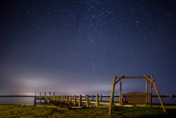 gliding swing and dock overlooking stars